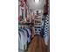 Spacious walk-in closet with organized shelving, hanging rods, and ample storage for clothing and accessories at 4383 Pool Rd, Winston, GA 30187