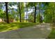 Long driveway leading to the home, surrounded by mature trees and landscaping at 4383 Pool Rd, Winston, GA 30187