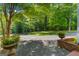 Scenic driveway framed by brick planters and lush greenery, leading to a peaceful retreat at 4383 Pool Rd, Winston, GA 30187
