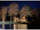 Stunning waterfront home at night with soft exterior lighting, reflecting on the water at 4383 Pool Rd, Winston, GA 30187