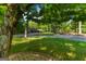 Detached three-car garage surrounded by mature trees along paved driveway at 4383 Pool Rd, Winston, GA 30187