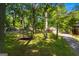 Relaxing gazebo nestled among mature trees with a view of the home's driveway and well-manicured lawn at 4383 Pool Rd, Winston, GA 30187