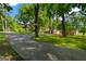 Ranch style home with brick exterior, large lawn and paved driveway lined with mature trees at 4383 Pool Rd, Winston, GA 30187