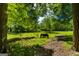 Lush wooded area with a picnic bench, showcasing the tranquility of the outdoors at 4383 Pool Rd, Winston, GA 30187