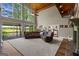 Open living room with high ceilings and a wall of windows overlooking the scenic backyard at 4383 Pool Rd, Winston, GA 30187