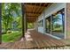 Covered porch overlooking the pond, features brick columns and a brick patio at 4383 Pool Rd, Winston, GA 30187
