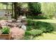 Landscaped backyard retreat with lounge chairs, pond, and bird feeders near the guest house at 206 Pine Cedar Cir, Brooks, GA 30205