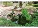 Tranquil backyard retreat featuring a water feature, owl statue, and wooden lounge chairs at 206 Pine Cedar Cir, Brooks, GA 30205