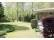 Green backyard view with trees, landscaping, grass and a screen porch on the home at 206 Pine Cedar Cir, Brooks, GA 30205
