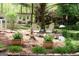 Serene backyard featuring landscaping, wooden chairs, and a guest house at 206 Pine Cedar Cir, Brooks, GA 30205
