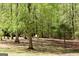 Secluded backyard retreat with mature trees, outdoor seating, and lush greenery at 206 Pine Cedar Cir, Brooks, GA 30205