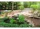 Picturesque backyard with a rock pond, lounge chairs, and a charming footbridge at 206 Pine Cedar Cir, Brooks, GA 30205