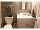 Cozy bathroom features a white toilet with gray towels and a white vanity cabinet at 206 Pine Cedar Cir, Brooks, GA 30205
