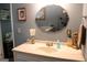 Bathroom featuring a vanity, oval mirror, and sconce lighting at 206 Pine Cedar Cir, Brooks, GA 30205