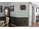Charming dining area featuring a grandfather clock, coffee art, and rustic wood-paneled walls at 206 Pine Cedar Cir, Brooks, GA 30205