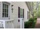 Charming exterior of home with light yellow siding, shutters and well maintained landscaping at 206 Pine Cedar Cir, Brooks, GA 30205