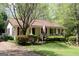Charming single-story home with a cozy front porch, American flag and well-manicured landscaping at 206 Pine Cedar Cir, Brooks, GA 30205