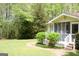 Charming home with a screened porch and a stone pathway surrounded by manicured landscaping at 206 Pine Cedar Cir, Brooks, GA 30205