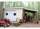 Detached garage with a covered area and various tools and equipment at 206 Pine Cedar Cir, Brooks, GA 30205