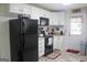 Bright kitchen featuring white cabinets, black appliances, and a vintage-inspired radio at 206 Pine Cedar Cir, Brooks, GA 30205