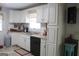 Well-lit kitchen featuring white cabinets, a neutral countertop, and a stainless steel double sink at 206 Pine Cedar Cir, Brooks, GA 30205