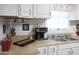 Functional kitchen featuring stainless steel sink, wood cutting board and updated appliances at 206 Pine Cedar Cir, Brooks, GA 30205