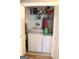Inside laundry room showcasing washer and dryer with overhead shelving and closet at 206 Pine Cedar Cir, Brooks, GA 30205