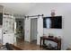 Contemporary living area featuring sliding barn doors, hardwood floors, and modern decor at 206 Pine Cedar Cir, Brooks, GA 30205