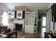 Open living space with a stylish fireplace, built-in shelving, and seamless flow into the dining area at 206 Pine Cedar Cir, Brooks, GA 30205