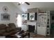Bright living room showcasing a brick fireplace with built-in shelving and hardwood flooring at 206 Pine Cedar Cir, Brooks, GA 30205