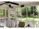 Screened-in porch offers serene views of the backyard and detached garage at 206 Pine Cedar Cir, Brooks, GA 30205