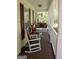 Inviting front porch with rocking chairs and porch swing at 206 Pine Cedar Cir, Brooks, GA 30205