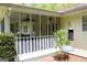 Home screened porch view with white railings, a ceiling fan, and surrounding greenery at 206 Pine Cedar Cir, Brooks, GA 30205