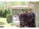 View of the screened porch with plants, a ceiling fan, and a stone patio at 206 Pine Cedar Cir, Brooks, GA 30205