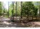 Property's perimeter is enclosed by a rustic fence, with trees providing privacy to the yard at 206 Pine Cedar Cir, Brooks, GA 30205