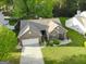 Bird's eye view of a brick home with a well-maintained lawn and driveway in a suburban neighborhood at 327 Viceroy Curv, Stockbridge, GA 30281