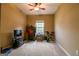 Bedroom with carpet, ceiling fan, and window with desk and exercise equipment at 327 Viceroy Curv, Stockbridge, GA 30281