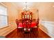 Traditional dining room with hardwood floors, elegant chandelier, and a classic china cabinet at 327 Viceroy Curv, Stockbridge, GA 30281