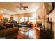 Spacious living room with fireplace, ceiling fan, hardwood floors, and comfortable seating at 327 Viceroy Curv, Stockbridge, GA 30281