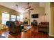 Bright living room featuring a fireplace, ceiling fan, hardwood floors, and comfortable seating at 327 Viceroy Curv, Stockbridge, GA 30281