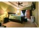 Main bedroom features a ceiling fan, coordinated lamps, and window views at 327 Viceroy Curv, Stockbridge, GA 30281