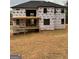 New construction home with black trim windows and a large wooden deck ready for the next phase at 421 Saint Surrey Way, Ellenwood, GA 30294