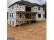 New construction home with black trim windows and a large wooden deck ready for the next phase at 421 Saint Surrey Way, Ellenwood, GA 30294