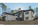Modern two-story home with stone accents, black trim windows, and a well-manicured lawn at 421 Saint Surrey Way, Ellenwood, GA 30294