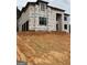 New construction home featuring black trim windows and house wrap ready for the next phase at 421 Saint Surrey Way, Ellenwood, GA 30294