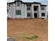 New construction home featuring black trim windows and house wrap ready for the next phase at 421 Saint Surrey Way, Ellenwood, GA 30294