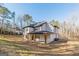 Rear exterior view of home with a covered patio and view of the back yard at 421 Saint Surrey Way, Ellenwood, GA 30294