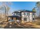 Rear exterior view of home showcasing covered patio and neutral color palette at 421 Saint Surrey Way, Ellenwood, GA 30294