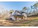 Rear exterior view of a newly built home with a covered patio and spacious backyard at 421 Saint Surrey Way, Ellenwood, GA 30294