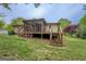 The home has a screened porch with stairs leading to the yard at 6950 Shannon Dr, Lithia Springs, GA 30122